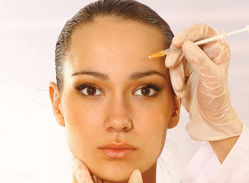Young woman receiving cosmetic facial injection for wrinkle reduction and skin rejuvenation.