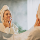Woman at home applying cream mask