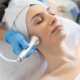 Young woman receiving a non-surgical facelift treatment at a clinic in Riyadh, cosmetologist performing skin rejuvenation on neck and face.