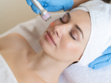 Dermatologist performing laser skin resurfacing treatment on patient