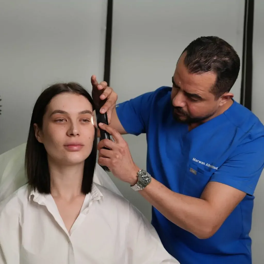 Patient receiving laser skin treatment at Reveal Clinics Riyadh