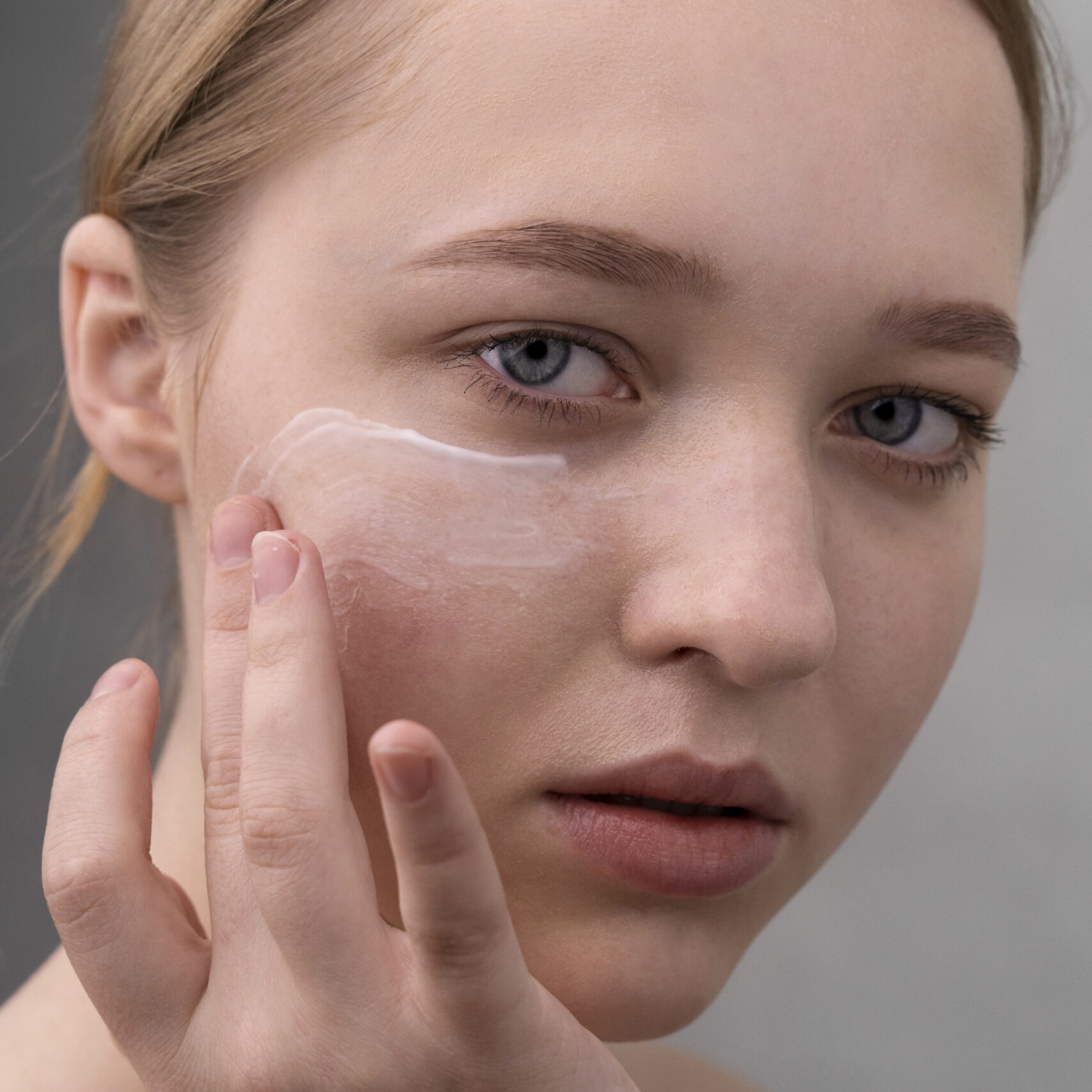 Woman applying SPF on her face as part of pigmentation care