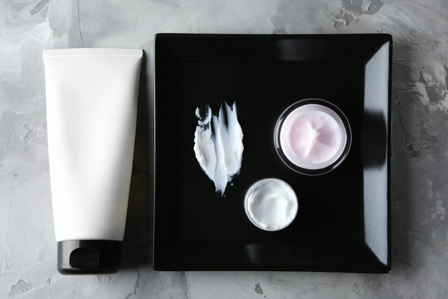 Tattoo removal aftercare products including ointment, SPF, and healing creams.