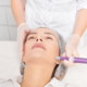 Dermatologist performing radiofrequency microneedling for non-surgical face lift.