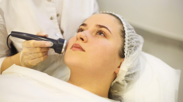Laser treatment being performed on facial pigmentation in a clinic