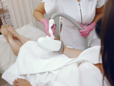 Woman receiving pain-free laser hair removal with AI device