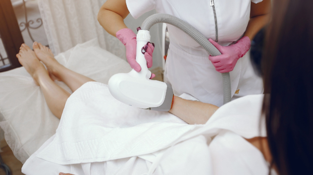 Woman receiving pain-free laser hair removal with AI device