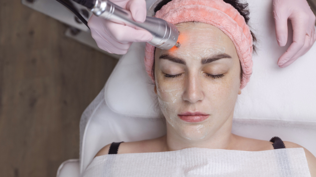 Dermatologist performing fractional CO₂ laser resurfacing treatment at Reveal Clinics Riyadh.