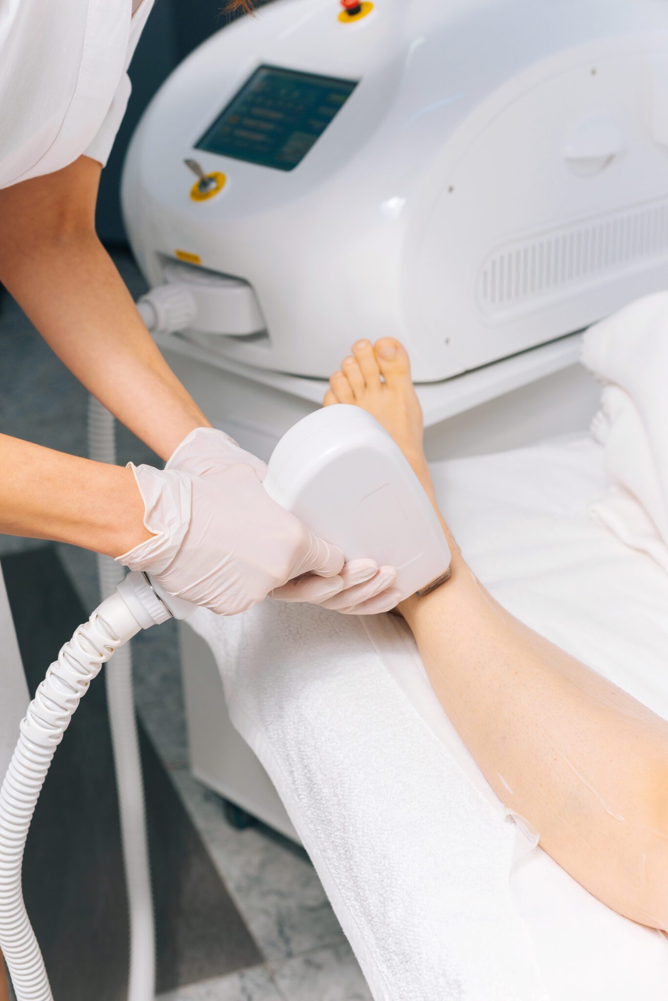 Dermatologist performing laser hair removal at Reveal Clinics